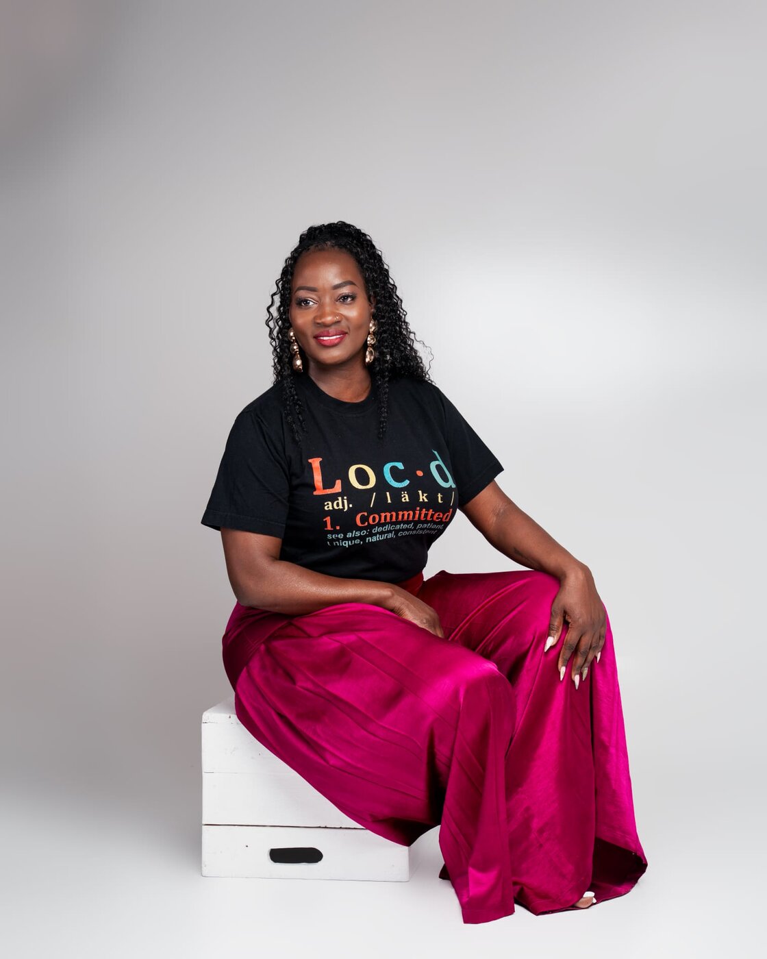 Loreta Waziri, founder of Radiant Locs, smiling